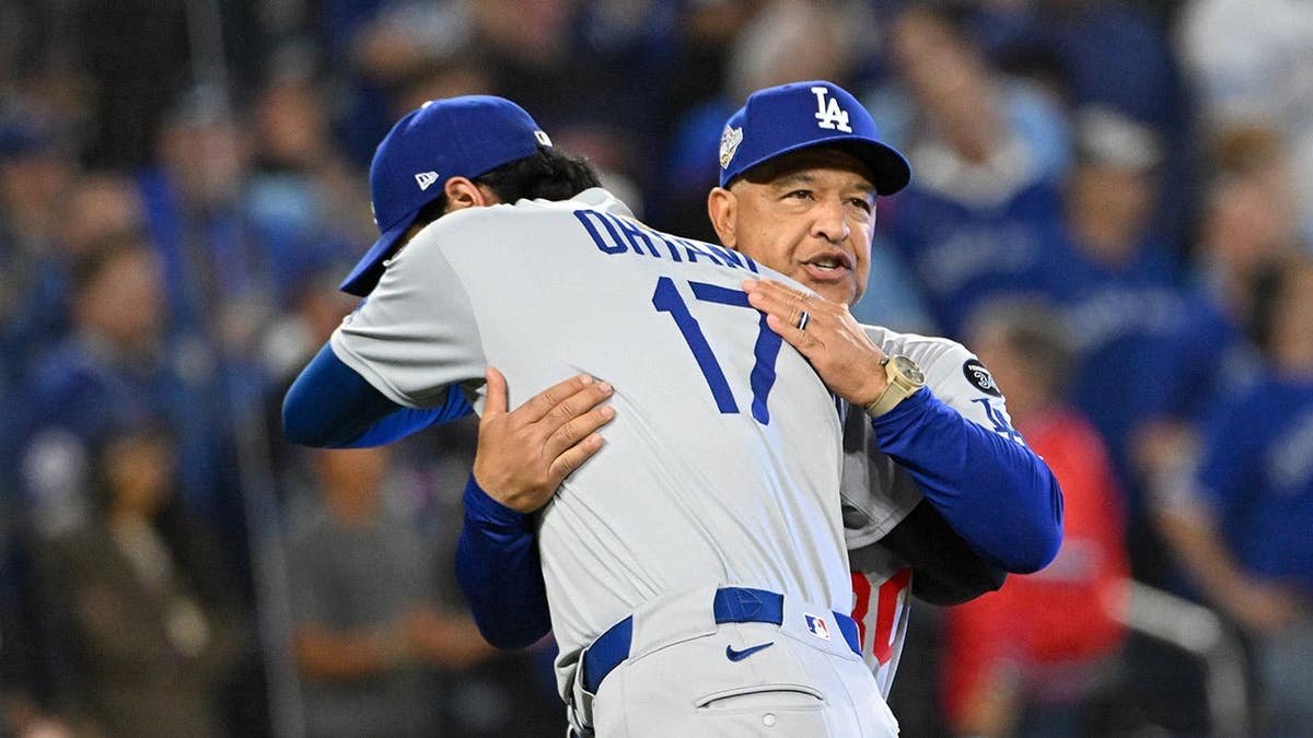 Shohei Ohtani greeting manager Dave Roberts during player introductions at Rogers Centre