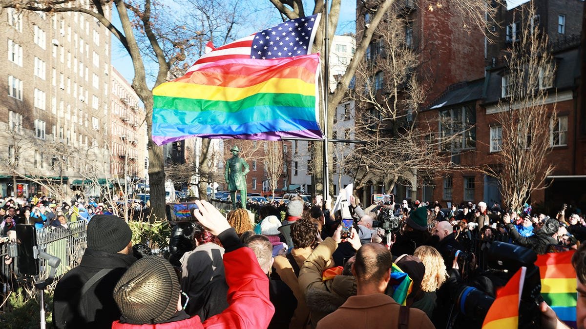 Senate Minority Leader Chuck Schumer watching local politicians raise LGBTQ+ Pride flag at Stonewall National Monument