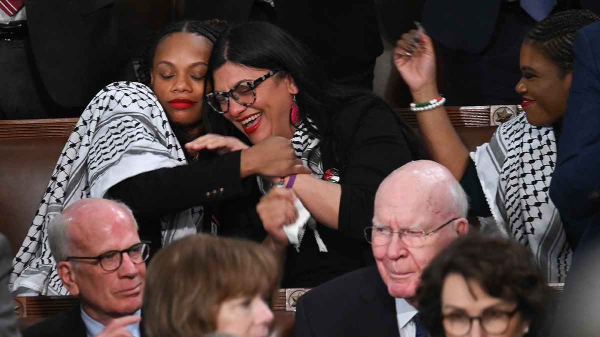 Rep. Summer Lee embracing Rep. Rashida Tlaib in the House Chamber during State of the Union address