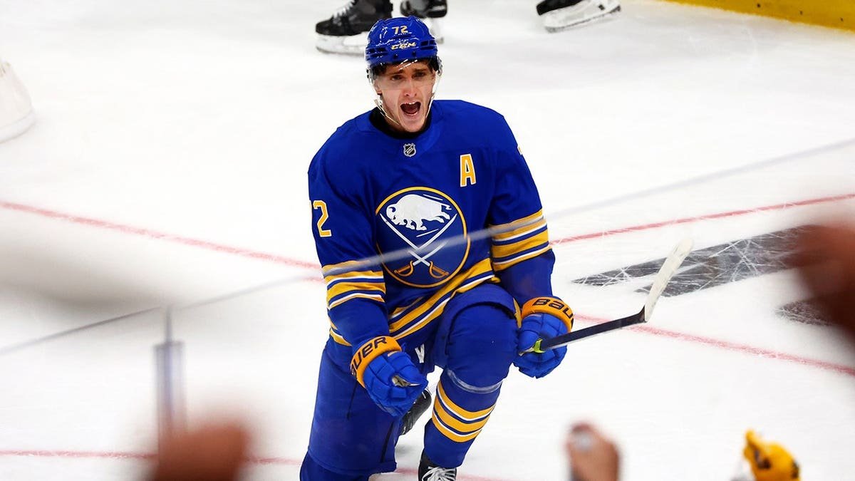 Buffalo Sabres center Tage Thompson celebrating a goal on ice rink.