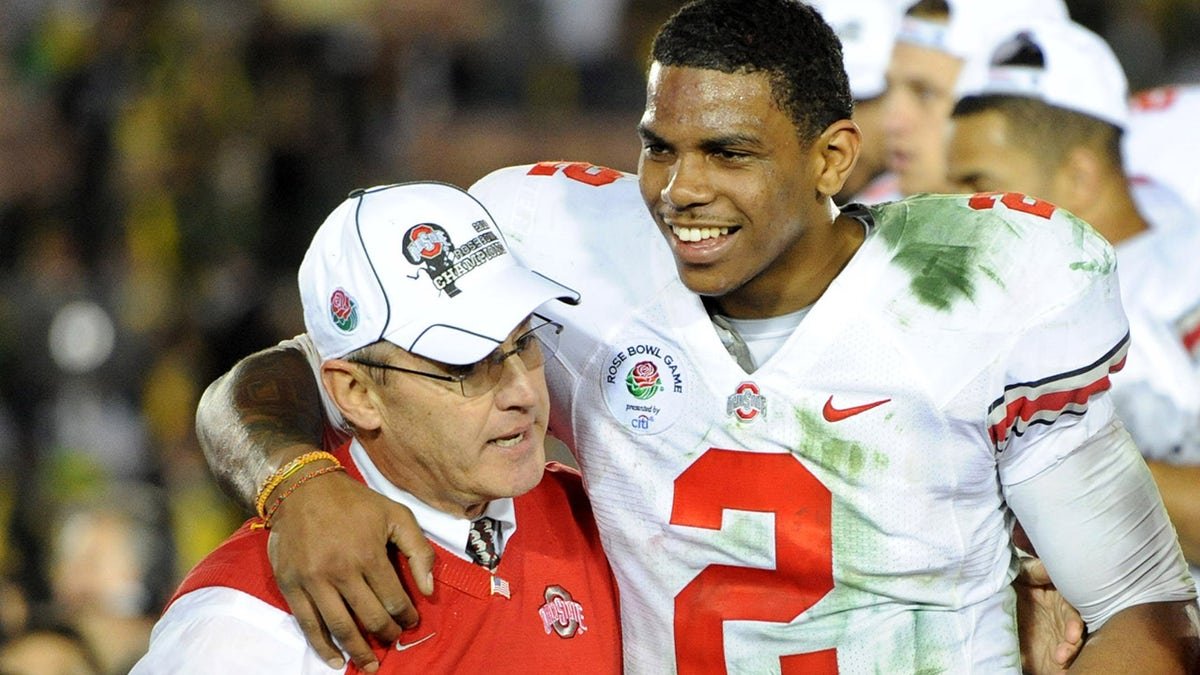 Ohio State quarterback Terrelle Pryor embraced by coach Jim Tressel and Ellen Tressel at Rose Bowl