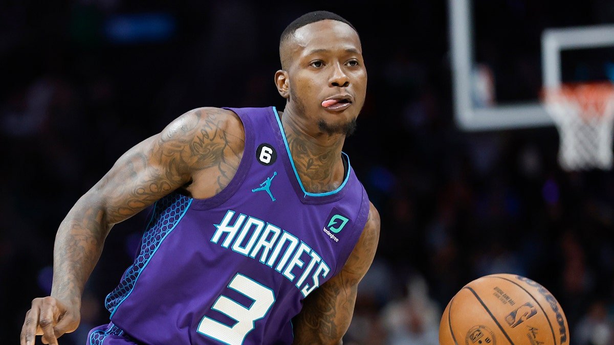 Charlotte Hornets guard Terry Rozier looking to pass during a basketball game