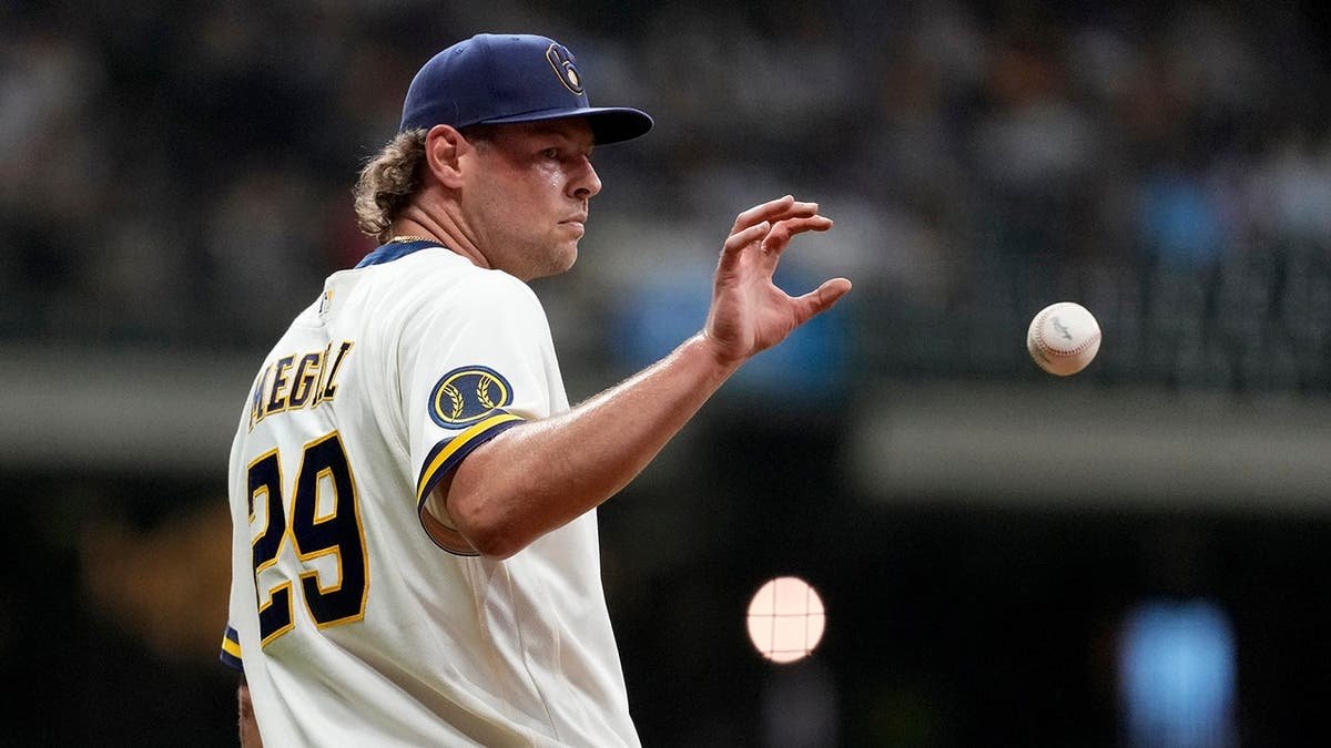 Trevor Megill catching a baseball during a game in Milwaukee