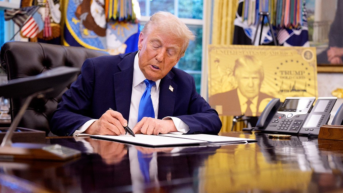 President Donald Trump signing an executive order in the Oval Office at the White House