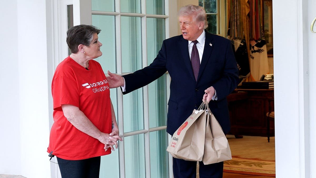 doordash driver hands mcdonalds to president trump outside oval office