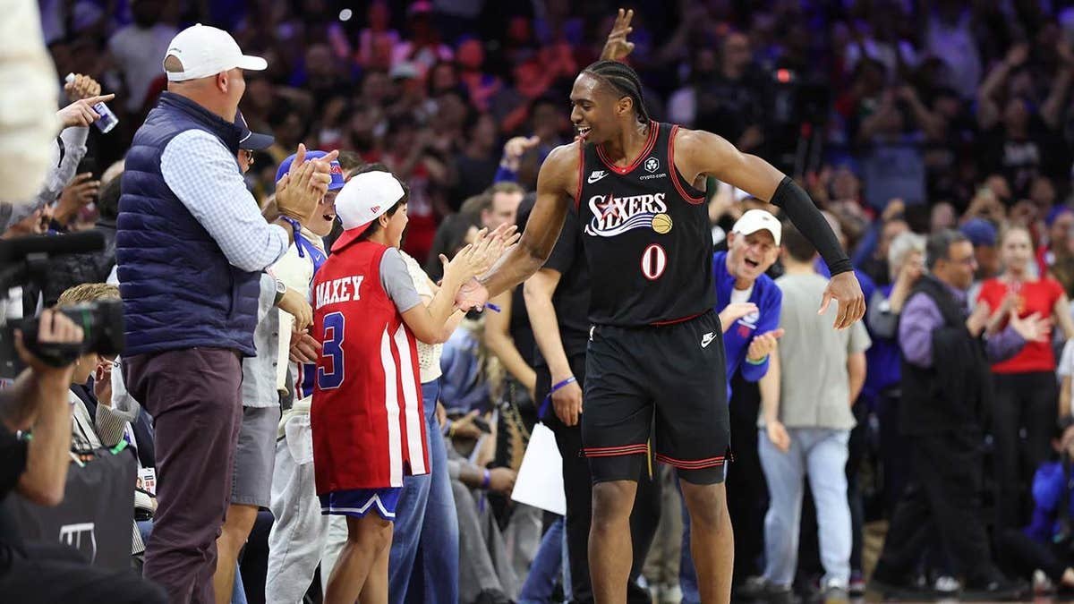 Philadelphia 76ers guard Tyrese Maxey reacting with fans at Xfinity Mobile Arena