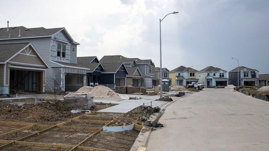 Homes under construction with storm in background