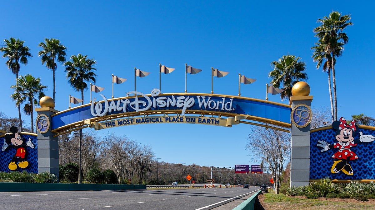 Walt Disney World entrance arch with Mickey and Minnie Mouse welcoming guests to 