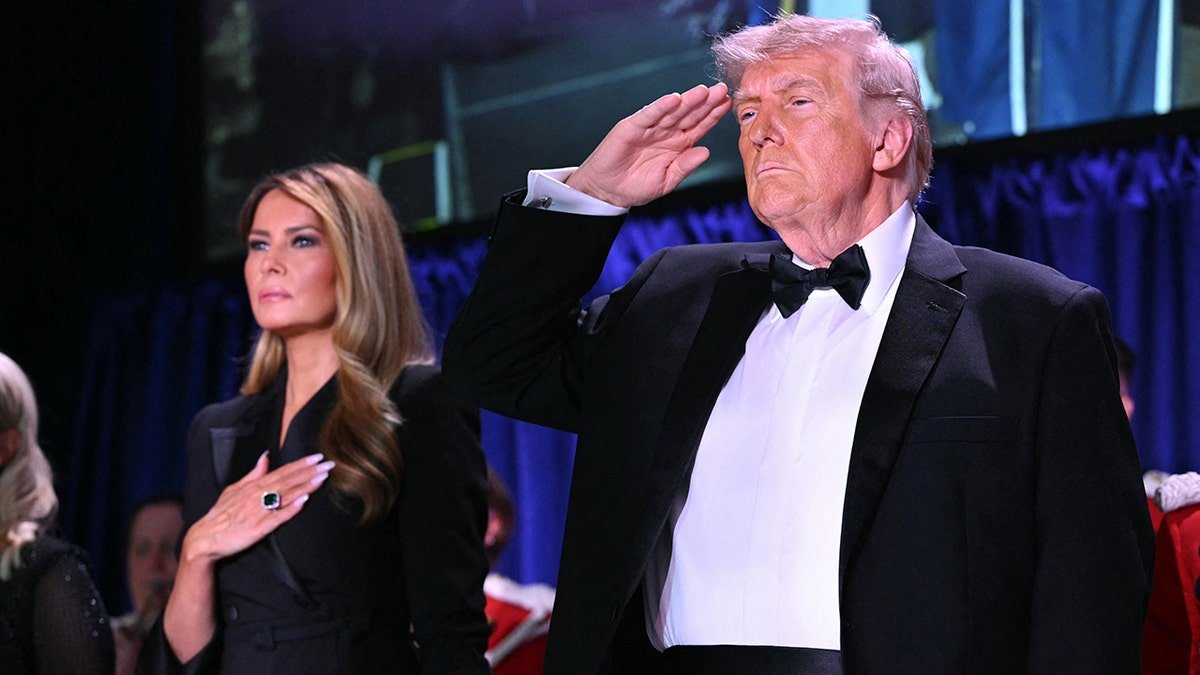 US First Lady Melania Trump and President Donald Trump standing together at the White House Correspondents' dinner
