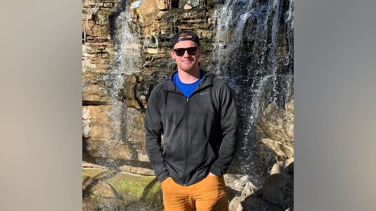 William Moffatt standing and smiling in a casual setting