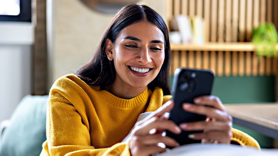 Woman smiles at phone
