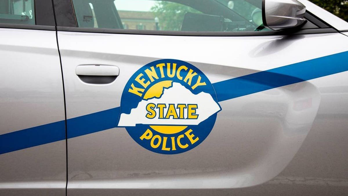 Kentucky State Police logo on cruiser vehicle.