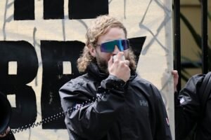 Joel Davis charged with hate speech after neo-Nazi rally outside NSW Parliament