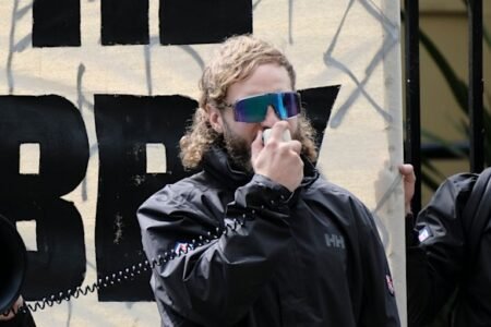 Joel Davis charged with hate speech after neo-Nazi rally outside NSW Parliament