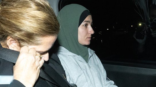 Janai Safar is escorted from Sydney Airport to Mascot police station after returning to Australia from Syria on Thursday night.