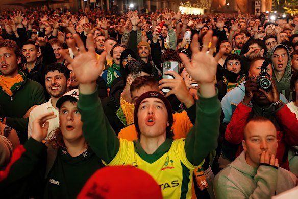 Socceroos fans watching a game on the big screen at Federation Square during the 2022 World Cup.