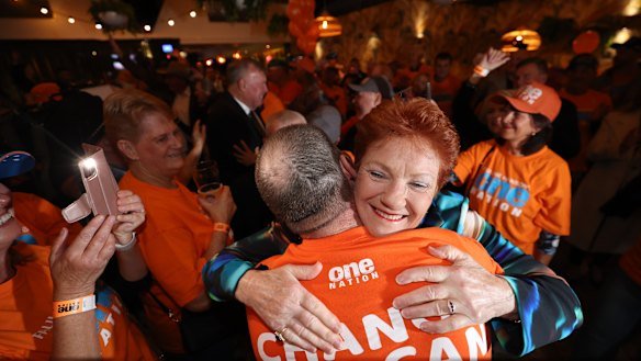 Pauline Hanson embraces a supporter at the One Nation HQ party in Albury on Saturday.