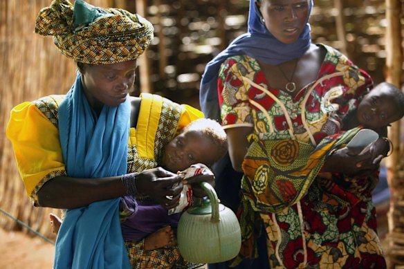 At a Doctors Without Borders feeding and treatment centre in Toibiri, Niger on a mother feeds her malnourished baby Plumpy’Nut.