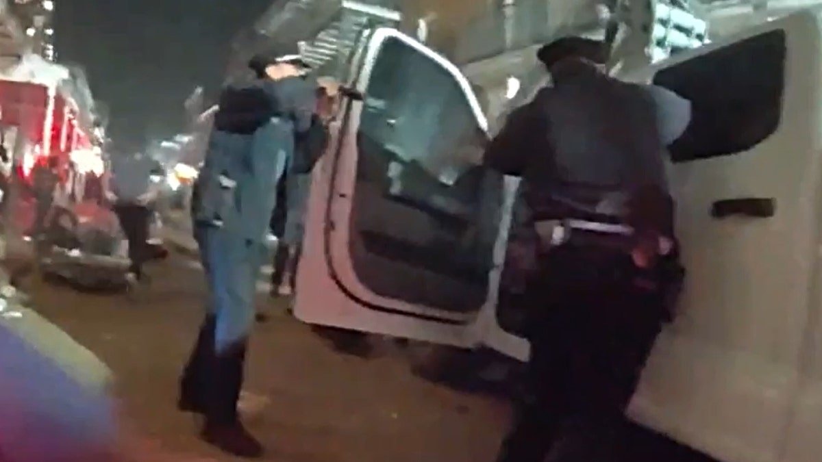 New Orleans police confronting Shamsud-Din Jabbar on a street.