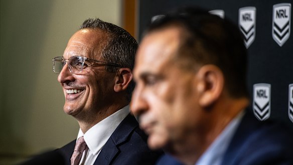 Andrew Abdo announces his departure from the NRL as chairman Peter V’landys looks on.