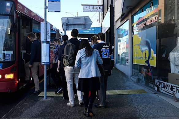 Passengers board a 500X express bus at a stop on Victoria Road in Drummoyne. 