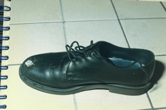 When the gunman shot one guard, the bullet ricocheted into the foot of the other - as shown in the guard’s shoe here with a bullet hole taken in evidence.