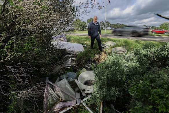 Whittlesea Mayor Lawrie Cox inspects dumped rubbish along a state-owned road in East Wollert.