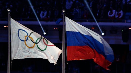 The Russian flag flies next to the Olympic flag at the closing ceremony of the 2014 Winter Games in Sochi.