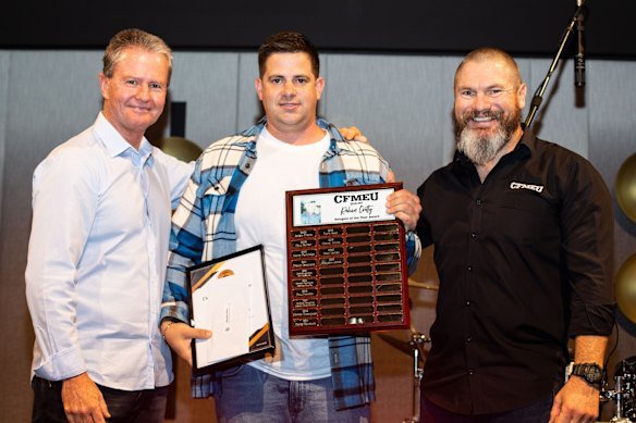 Hayden Jones receiving an award for his CFMEU work on the Cairns Convention Centre site, with Michael Ravbar (left) and Jade Ingham.