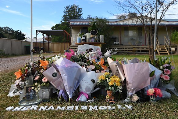 Flowers and tributes left outside the home of Molly Ticehurst in Forbes.