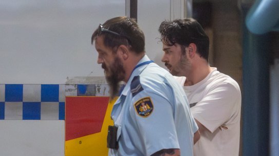 Benjamin David Collinge, is transported from Burwood Local Court. The teacher has been charged 