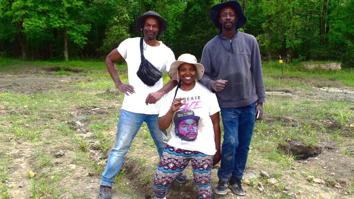 Keshia holding diamond next to her brother, boyfriend