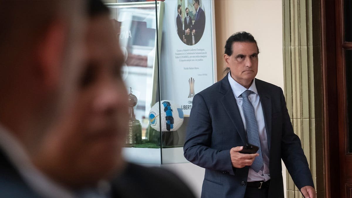 saab wearing suit and walking
