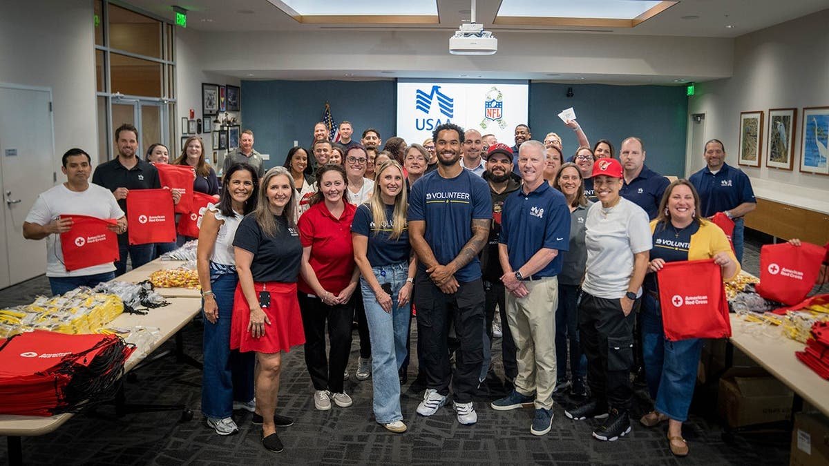 Emeka Egbuka with USAA volunteers
