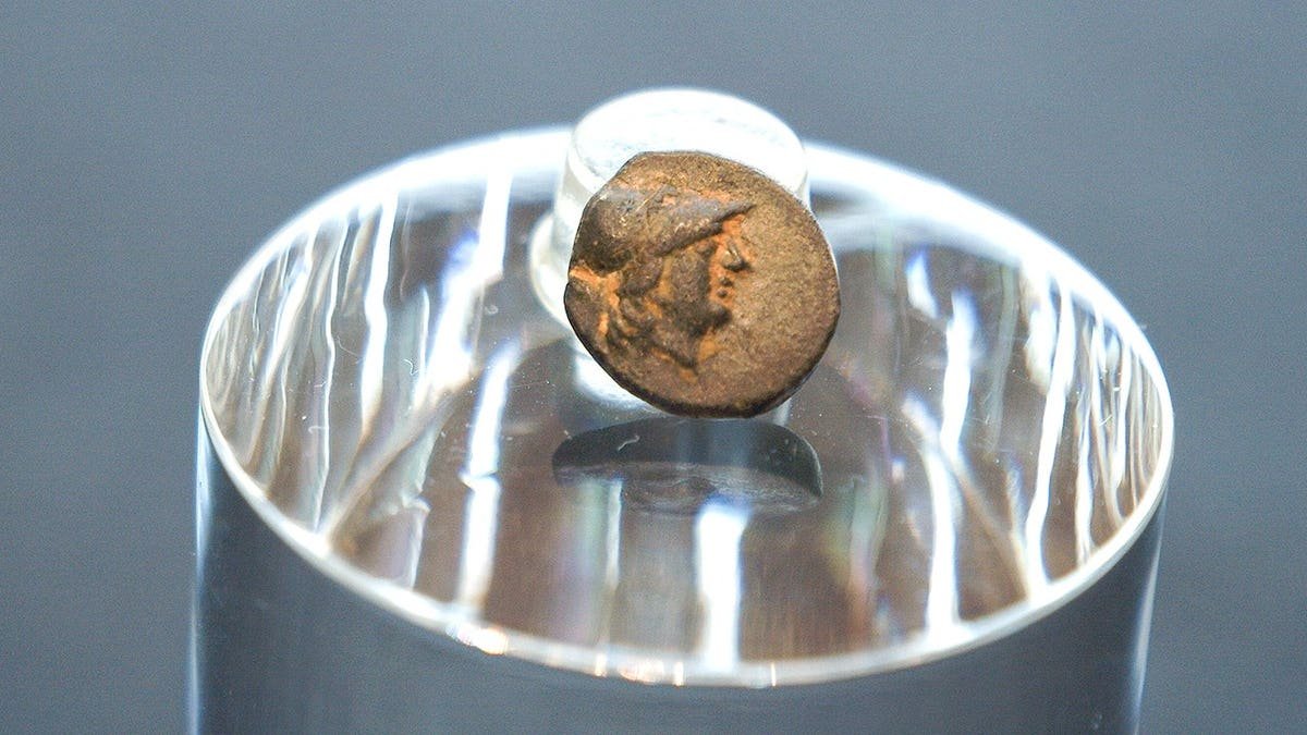 Small Greek coin on display at museum
