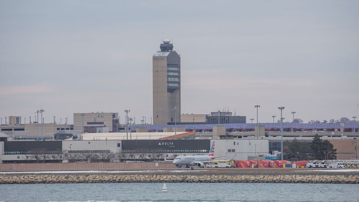 Air traffic control tower and planes at Boston Logan Airport