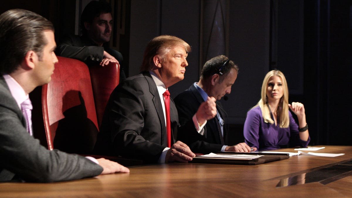 Donald Trump standing with Donald Trump Jr and Ivanka Trump at Celebrity Apprentice season finale