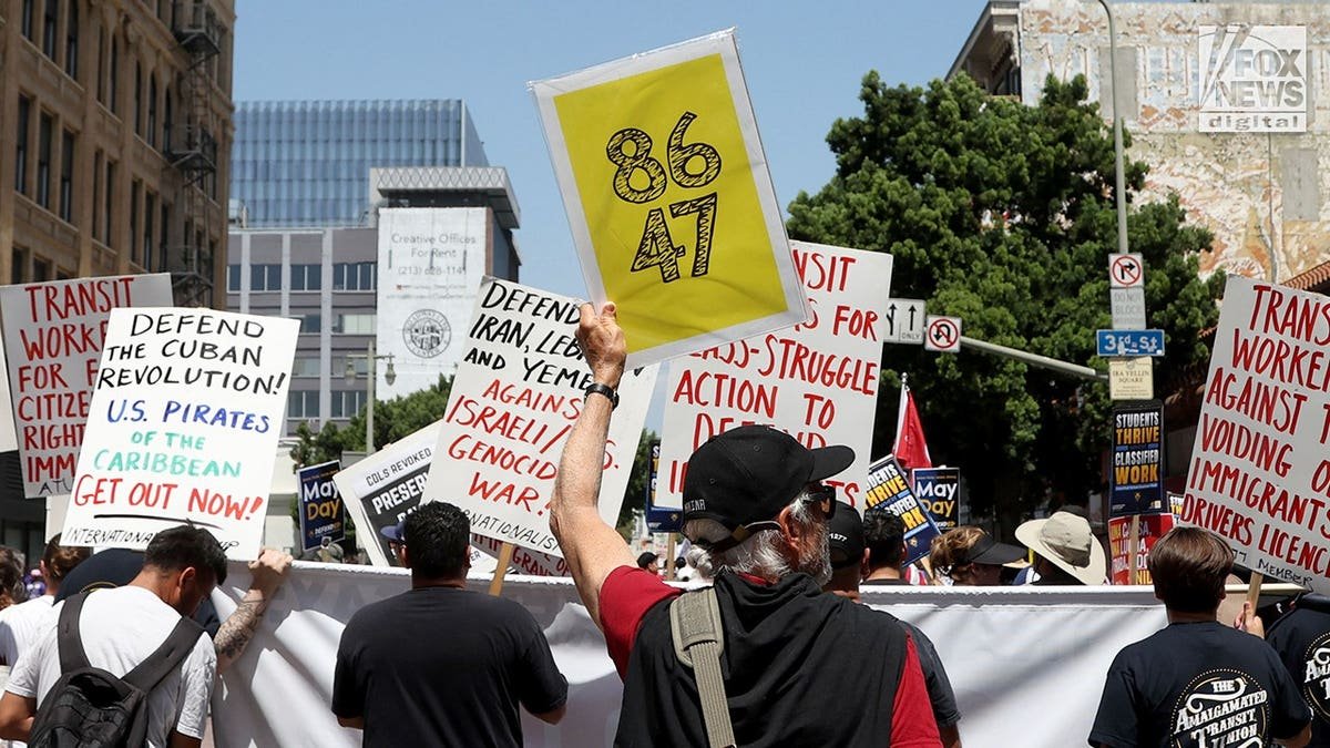 Protester holds '86 47' sign during May Day demonstration in Los Angeles, California
