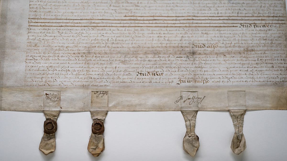 Researcher holding 1613 Shakespeare deed document