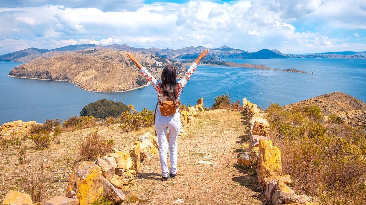 Tourist standing near Lake Titicaca