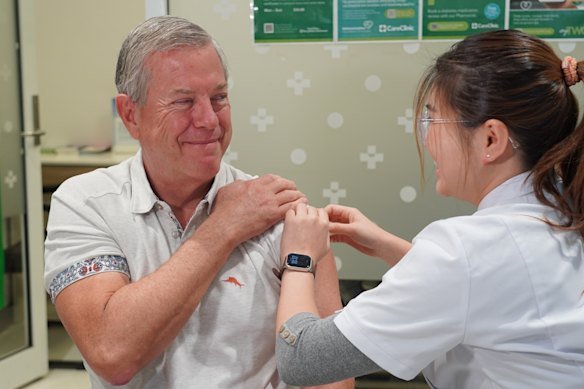 Tim Nicholls gets a vaccination before announcing an expansion of the needle-free flu mist program.