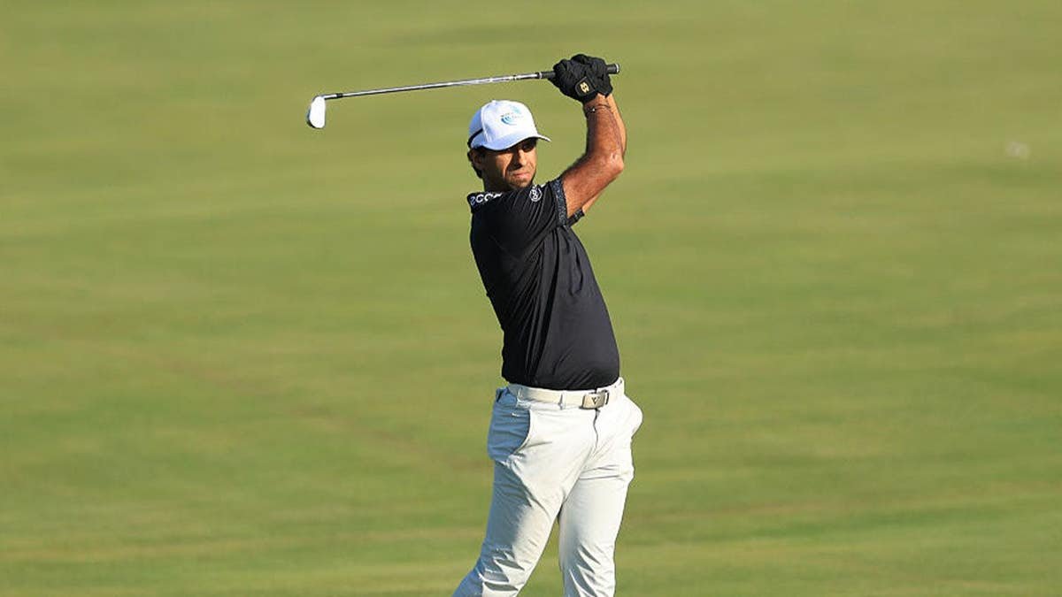 Aaron Rai of England hits an iron
