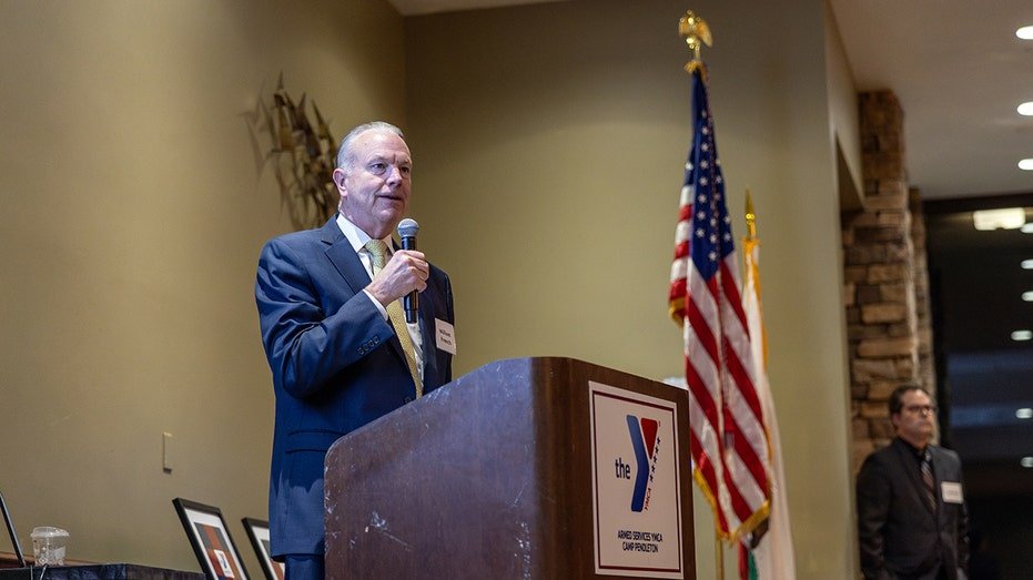 Retired U.S. Navy Vice Adm. William French speaks at podium at Camp Pendleton