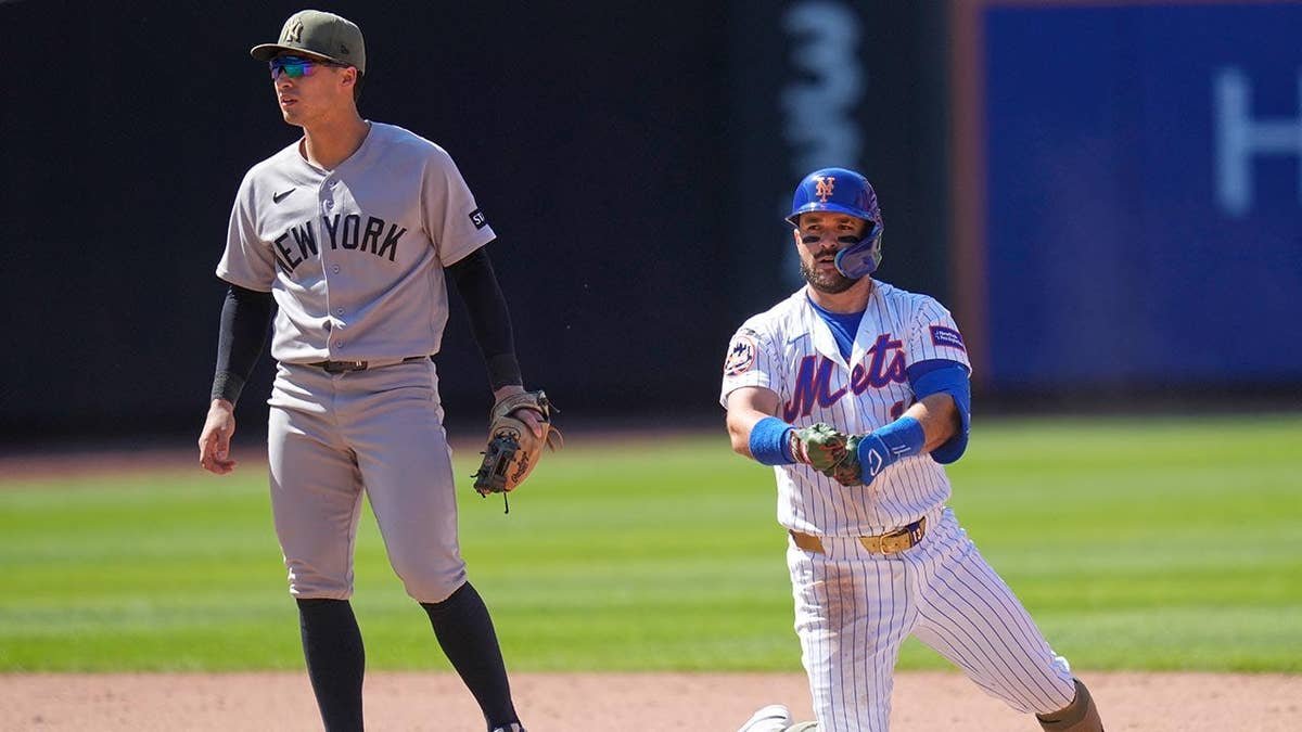 New York Yankees shortstop Anthony Volpe watching New York Mets' Luis Torrens after hitting a two-run RBI double.