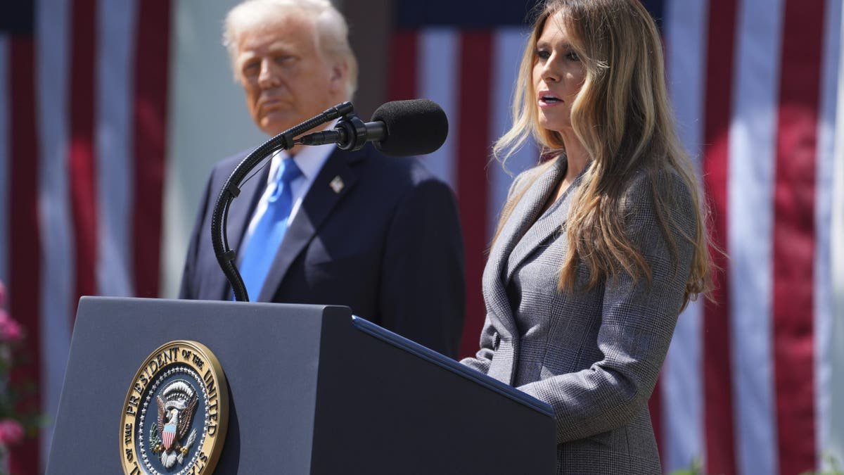First lady Melania Trump speaking while President Donald Trump listens in the White House Rose Garden