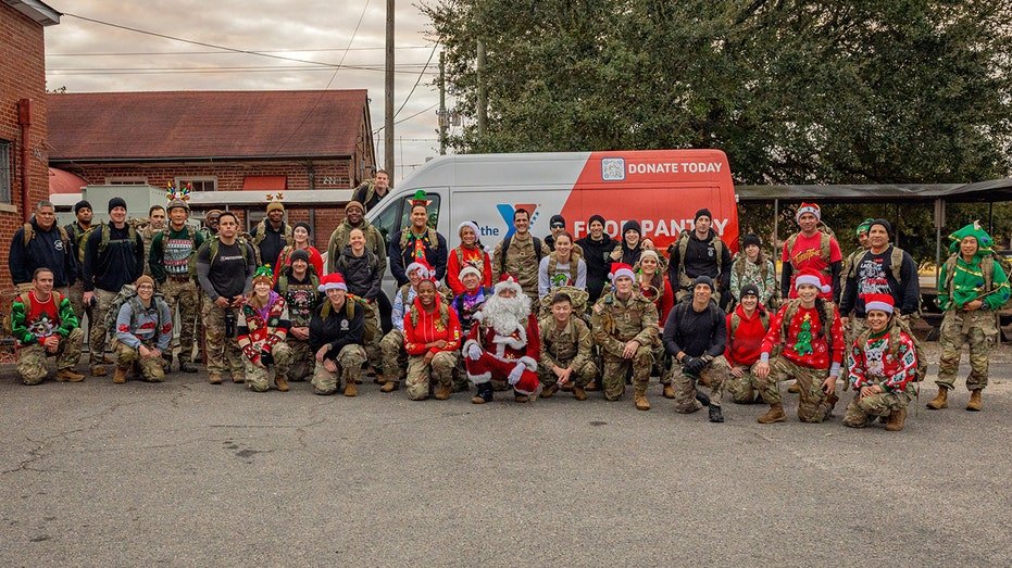 ASYMCA and Members of the 1st Special Forces Command show off Christmas Toy/Food drive