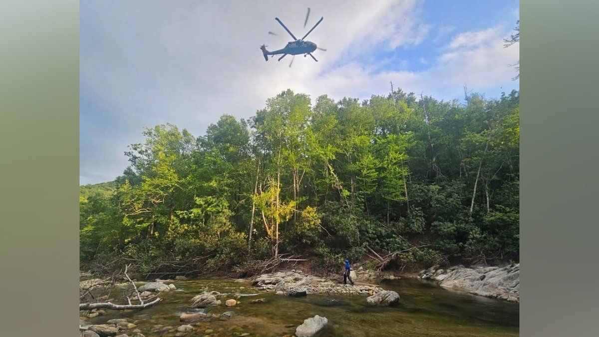 A Black Hawk helicopter flying over wooded area in Avery County North Carolina