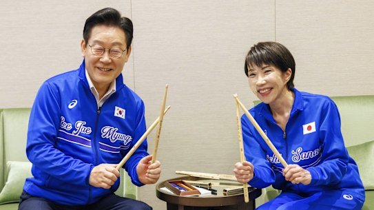 Japanese Prime Minister Sanae Takaichi, right, is popular with younger voters, in part due to her willingness to break the mould like drumming KPOP songs with South Korean President Lee Jae Myung.