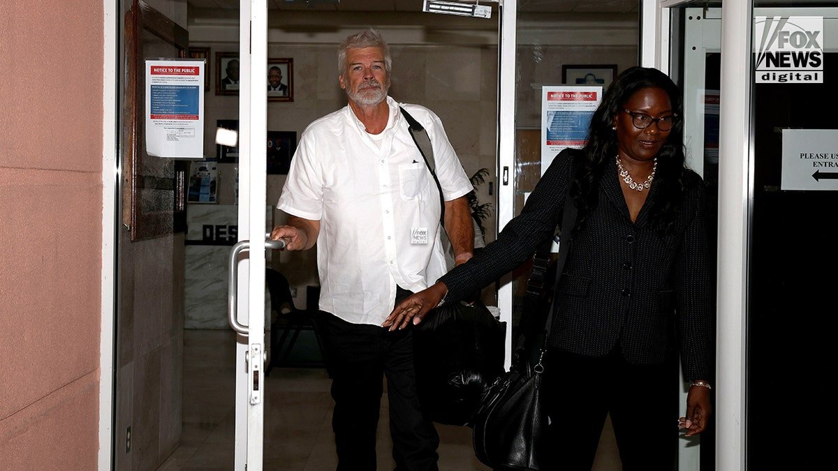 Brian Hooker leaving Central Police Station in Freeport accompanied by lawyer Terrel A. Butler