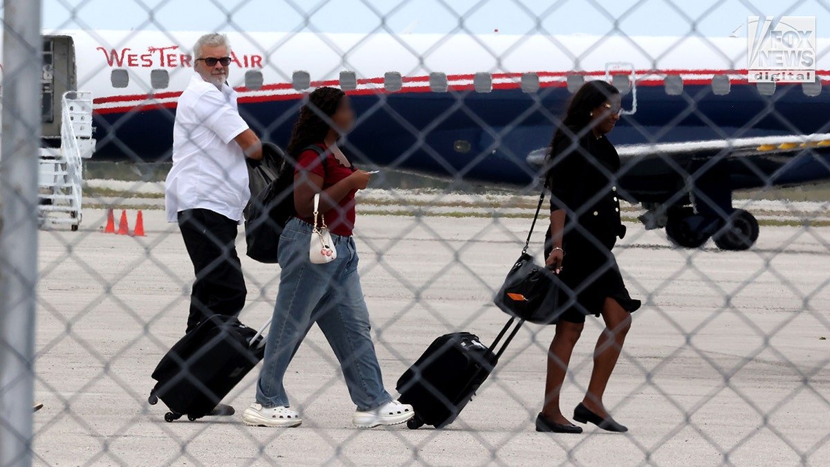Brian Hooker boarding a plane at Grand Bahama Freeport Airport with lawyer Terell A. Butler